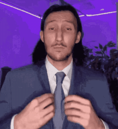Man With Long Hair And Mustache Wearing Suit And Tie GIF