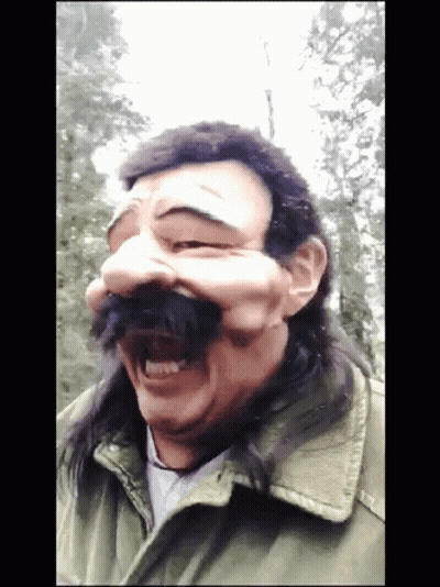 Man With Long Hair And Mustache Wears Mask GIF