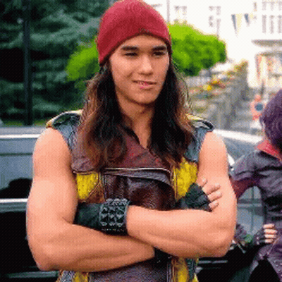 Man With Long Hair And Red Hat Arms Crossed GIF
