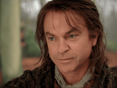 Man With Long Hair and Scarf Looking at Camera