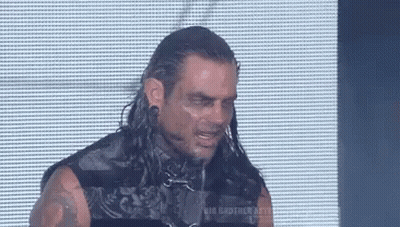 Man With Long Hair And Tattoos Eyes Closed In Front Of Screen GIF