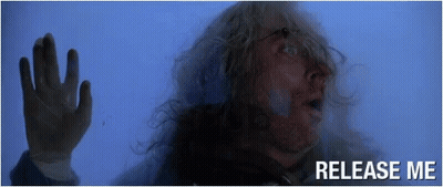 Man With Long Hair Behind Glass Saying Release Me GIF