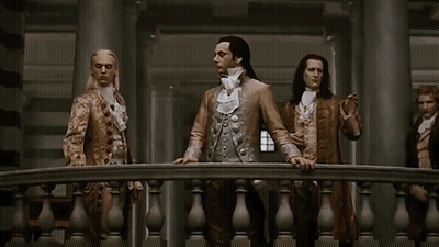 Man With Long Hair Between Two Men GIF