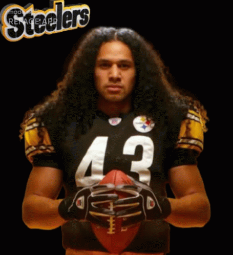 Man With Long Hair Holding Football GIF