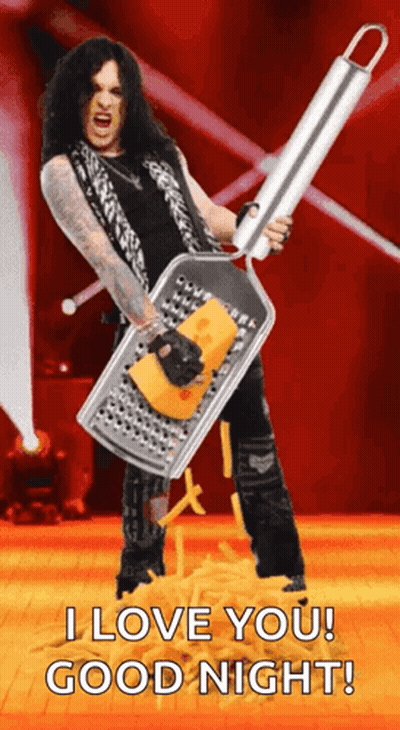 Man With Long Hair Holding Grater With Cheese GIF