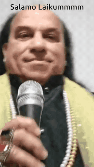 Man With Long Hair Holding Microphone GIF