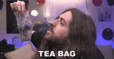 Man With Long Hair Holding Tea Bag GIF