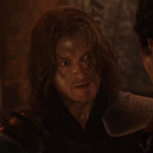 Man With Long Hair In Armor Looking At Another Man GIF
