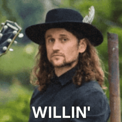 Man With Long Hair In Black Hat Holding Guitar 'Willin GIF