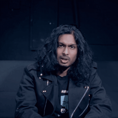 Man With Long Hair In Black Jacket And Skull Shirt GIF