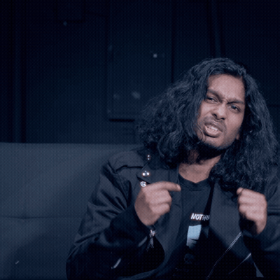 Man With Long Hair In Black Shirt Saying Nothing GIF
