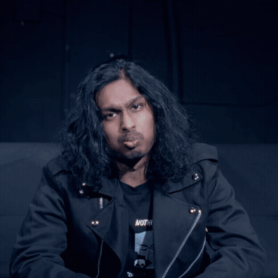 Man With Long Hair In Black Shirt Saying Nothing GIF