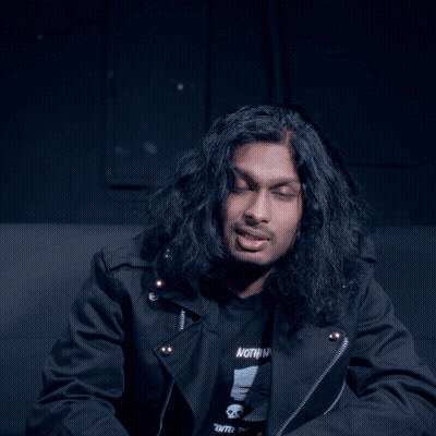 Man With Long Hair In Black Shirt Saying Vote GIF