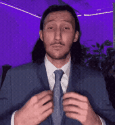 Man With Long Hair In Blue Suit And Tie GIF
