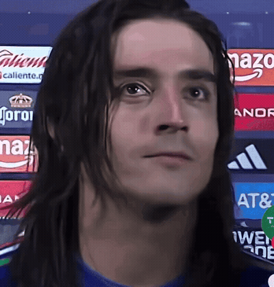 Man With Long Hair In Front Of Corona Ads GIF