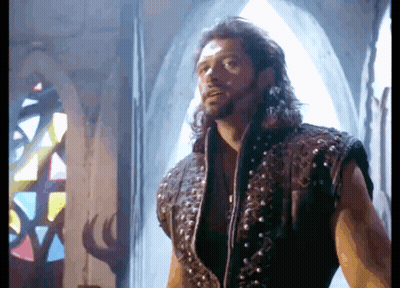Man With Long Hair In Front Of Stained Glass Window GIF
