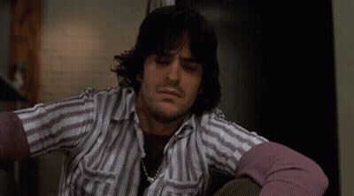 Man With Long Hair In Striped Shirt And Purple Sweater GIF