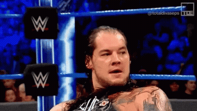 Man With Long Hair In Wrestling Ring With W Logo GIF