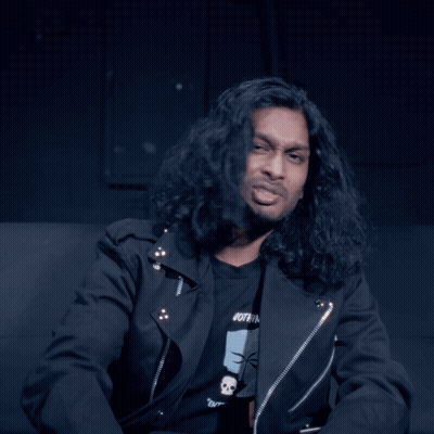Man With Long Hair Looking At Camera GIF