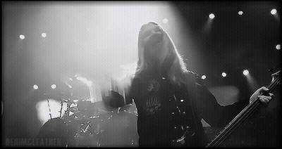 Man With Long Hair Playing Bass Guitar On Stage GIF