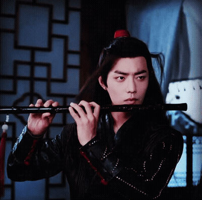 Man With Long Hair Playing Flute