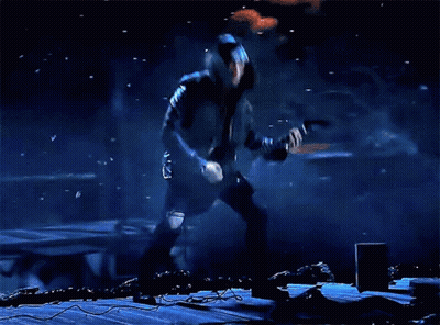 Man With Long Hair Playing Guitar in Dark