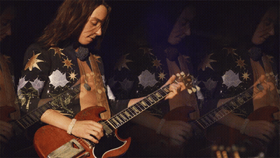 Man With Long Hair Playing Guitar In Mirror GIF