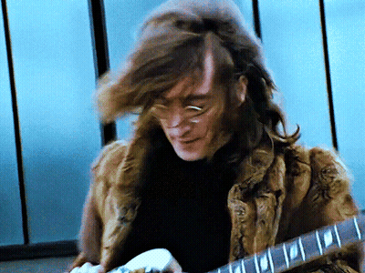Man With Long Hair Playing Guitar GIF
