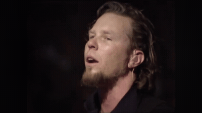 Man With Long Hair Singing Into Mic GIF