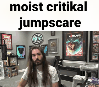 Man With Long Hair Sitting In Front Of Sign Saying Moist Critical Jumpscare GIF