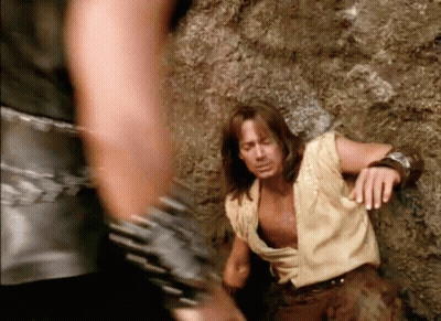 Man With Long Hair Standing Beside Man Holding His Waist GIF
