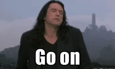 Man With Long Hair Standing In Front Of Go On Sign GIF