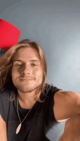 Man With Long Hair Wearing Black Shirt GIF