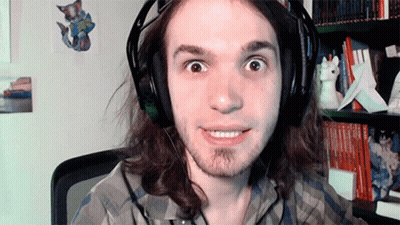 Man With Long Hair Wearing Headphones And Plaid Shirt Smiling GIF