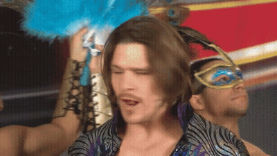 Man With Long Hair Wearing Mask Holding Blue Feather GIF
