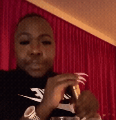 Man With Long Nails Holding Wine GIF