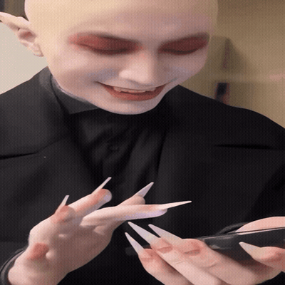 Man With Long Nails Looking At Phone GIF