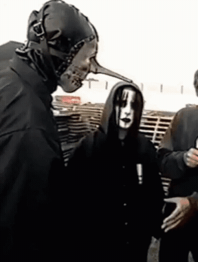 Man With Long Nose Mask Talks To Another Man GIF