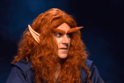 Man With Long Red Hair And Elf Ears Looking At Camera GIF
