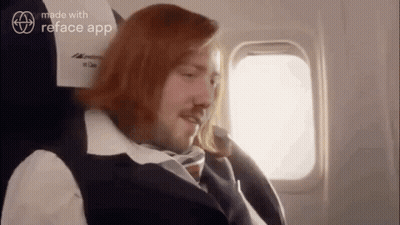 Man With Long Red Hair Sitting On Plane GIF