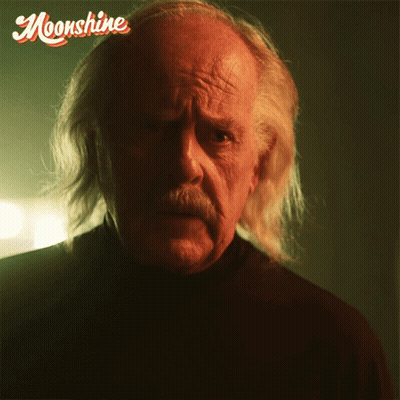 Man With Long White Hair And Mustache Looking At Camera Saying Moonshine GIF