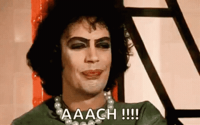 Man With Makeup Pearl Necklace Green Shirt GIF