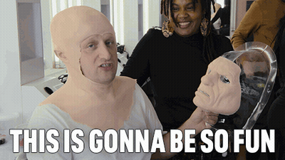 Man With Mask Beside Woman Holding Mannequin Head This Is Gonna Be So Fun GIF