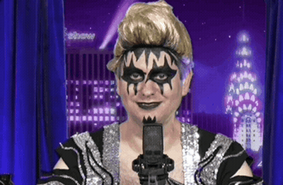 Man With Mask Holding Microphone In Front Of Febbane Building GIF