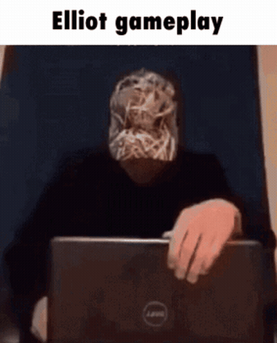 Man With Mask Sitting at Laptop