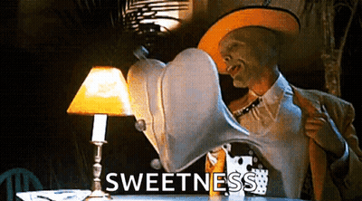 Man With Mask Sitting At Table With Lamp And Sweetness GIF