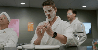 Man With Mask Sitting At Table With Two Men GIF