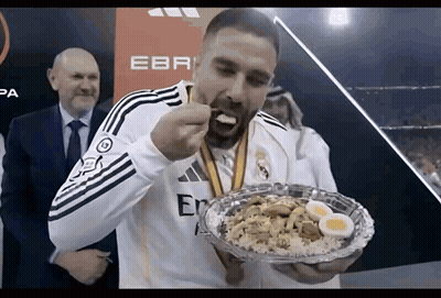 Man With Medal Eating Food GIF