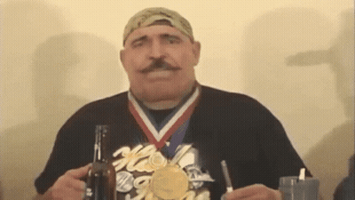 Man With Medal Holding Beer Bottle And Glass GIF