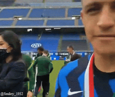 Man With Medal In Front Of Stadium GIF